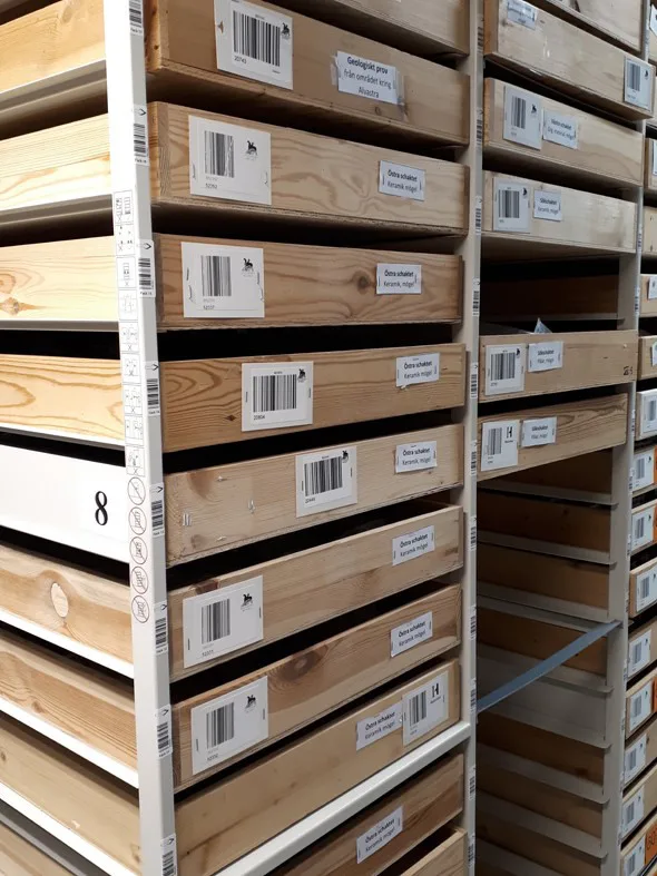 Wooden archeological storage boxes in storage facility from Mats P. Malmer’s excavations