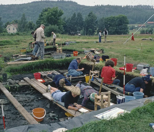 Archeologist working in excavation pit