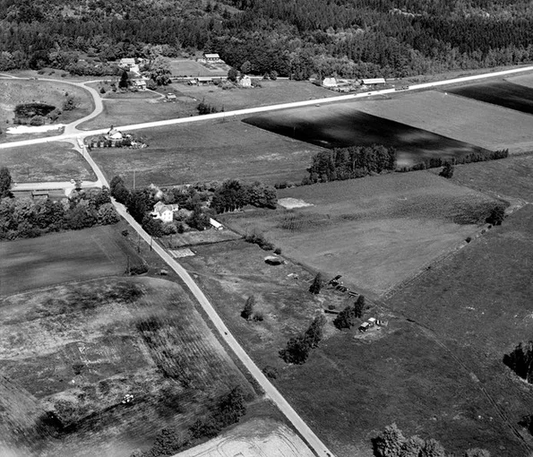 Black white aerial photo of  roads, houses and greenery