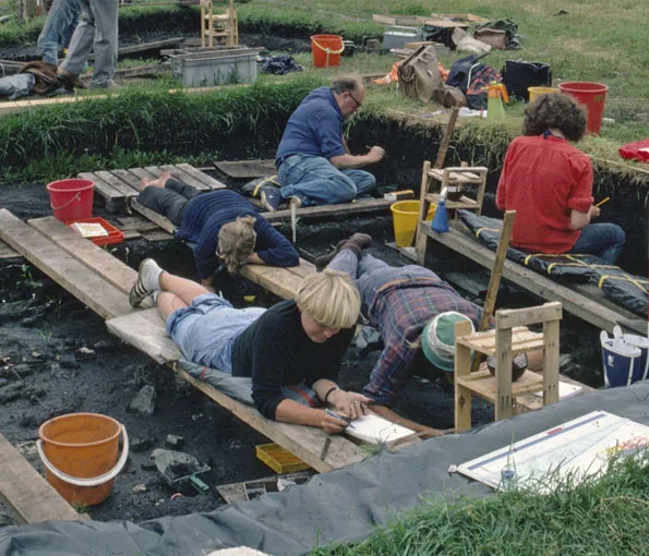Archeologist working in excavation pit