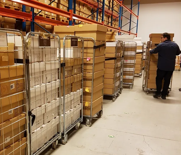 Museum staff moving boxes in storage facility